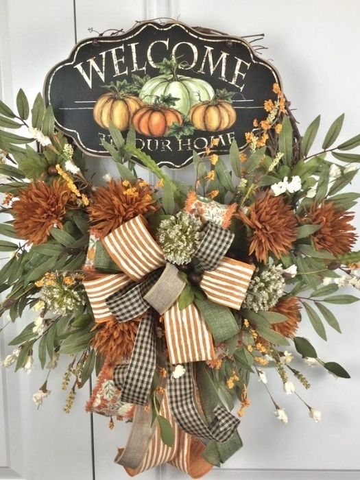 fall wreath with bow and sign with pumpkins